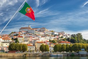 View on the old university city of Coimbra and the medieval capital of Portugal with Portuguese flag, Europe-کاماپرس